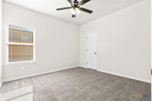 carpeted spare room featuring ceiling fan