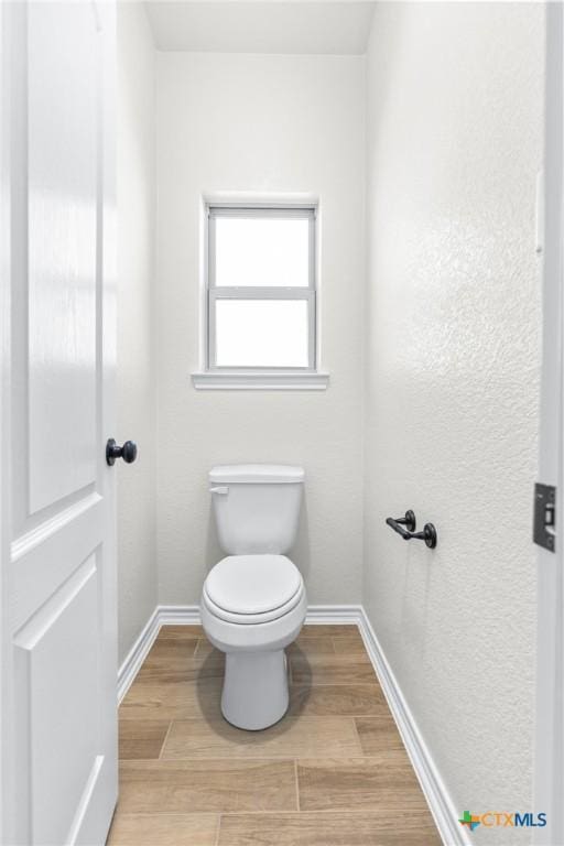 bathroom featuring toilet and hardwood / wood-style flooring