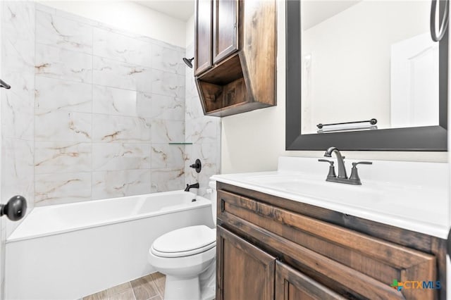 full bathroom featuring hardwood / wood-style flooring, tiled shower / bath combo, toilet, and vanity