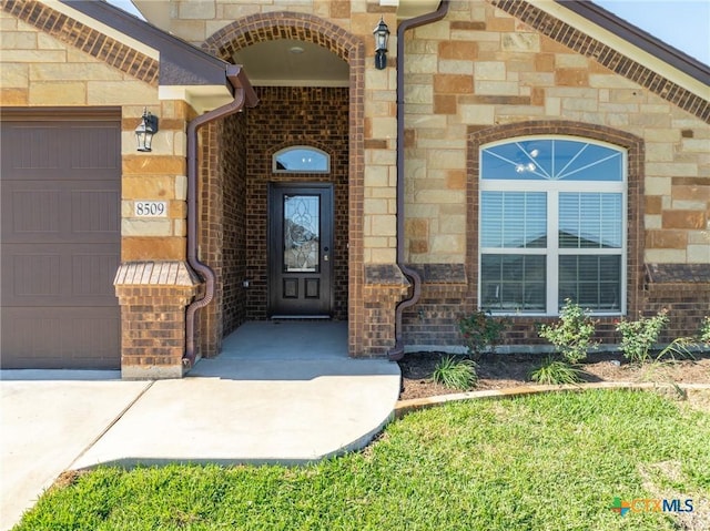 view of exterior entry featuring a garage