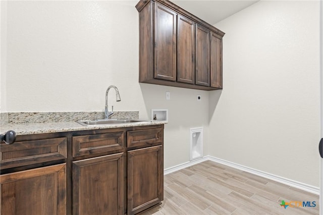 laundry room with electric dryer hookup, cabinets, sink, hookup for a washing machine, and light hardwood / wood-style flooring