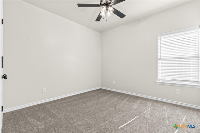 empty room with carpet, plenty of natural light, and ceiling fan