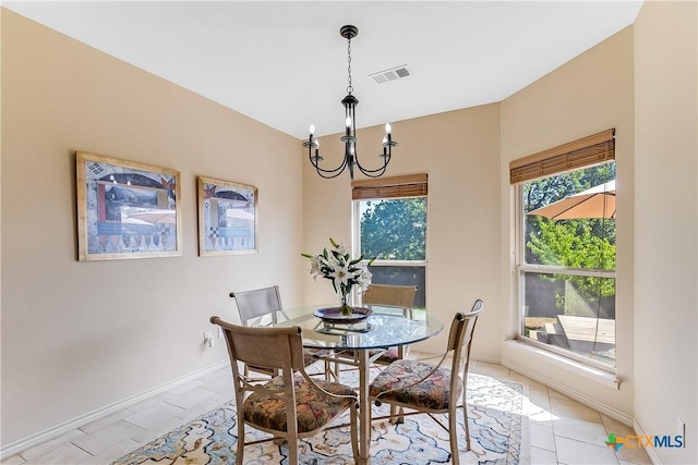 1518 Skyline Dr, Kingsland, TX 78639 - dining room with a chandelier, baseboards, and light tile patterned floors