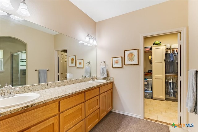 1518 Skyline Dr, Kingsland, TX 78639 - full bath featuring a stall shower, double vanity, a walk in closet, and baseboards