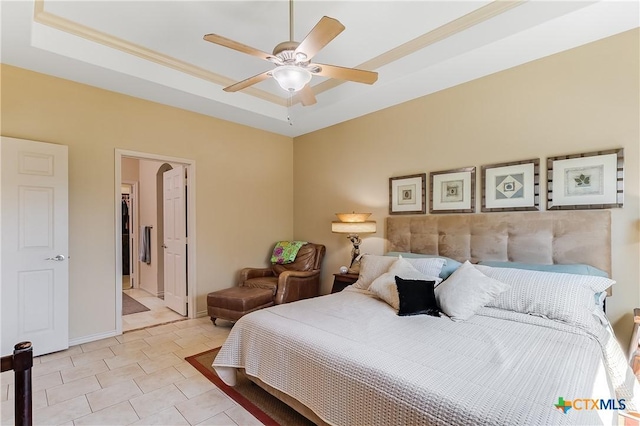 1518 Skyline Dr, Kingsland, TX 78639 - bedroom featuring a tray ceiling, ceiling fan, arched walkways, and baseboards