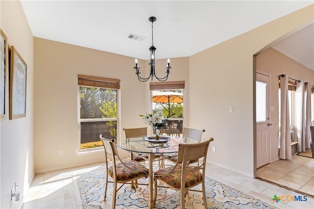 1518 Skyline Dr, Kingsland, TX 78639 - dining room with arched walkways, light tile patterned floors, a chandelier, and baseboards