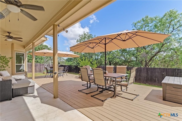 1518 Skyline Dr, Kingsland, TX 78639 - wooden terrace with outdoor dining area, ceiling fan, and a fenced backyard