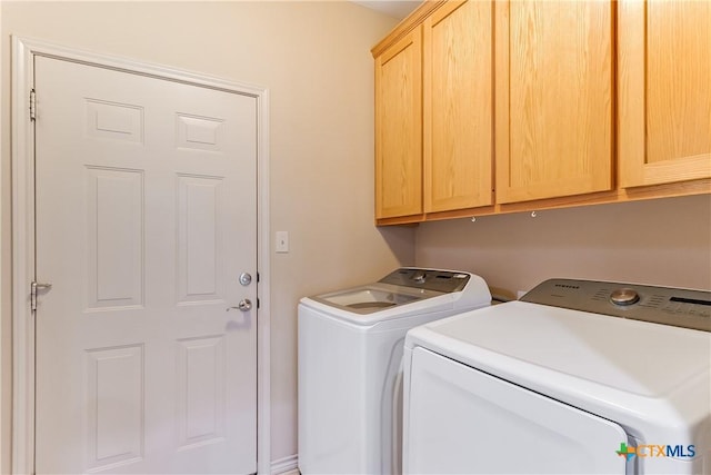 1518 Skyline Dr, Kingsland, TX 78639 - laundry room featuring washer and dryer and cabinet space