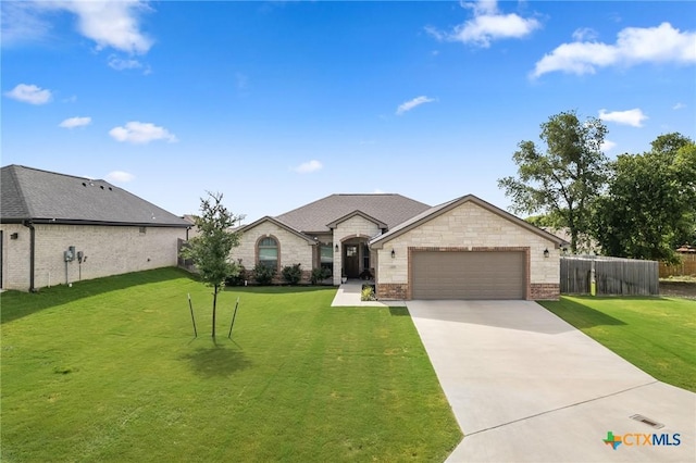 705 Juniper Dr, Troy, TX 76579 - french country home featuring an attached garage, driveway, and brick siding