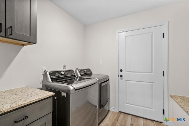 705 Juniper Dr, Troy, TX 76579 - laundry room with cabinet space, washing machine and dryer, and light wood finished floors