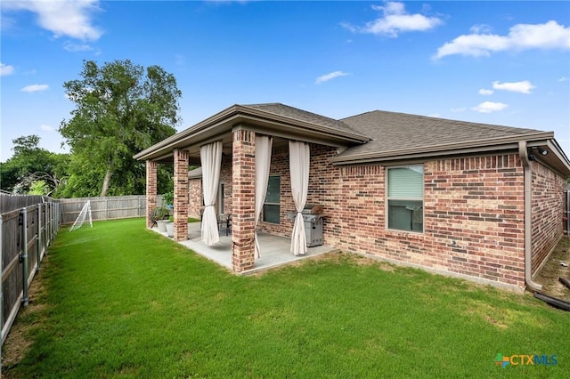 705 Juniper Dr, Troy, TX 76579 - back of property featuring brick siding, a fenced backyard, and roof with shingles