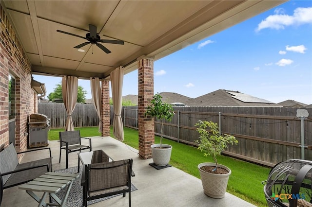 705 Juniper Dr, Troy, TX 76579 - fenced backyard with ceiling fan, area for grilling, a patio area, and an outdoor living space