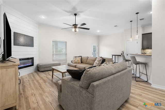 705 Juniper Dr, Troy, TX 76579 - living area featuring ornamental molding, a ceiling fan, light wood finished floors, a large fireplace, and recessed lighting