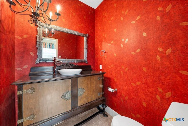 bathroom featuring tile patterned flooring, vanity, and toilet