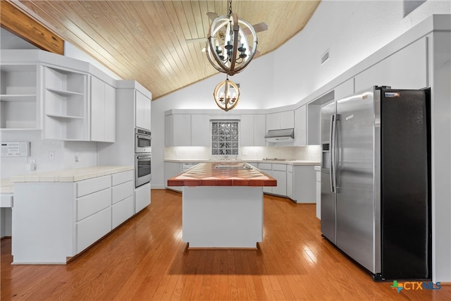 kitchen featuring light hardwood / wood-style flooring, a kitchen island, hanging light fixtures, and stainless steel appliances