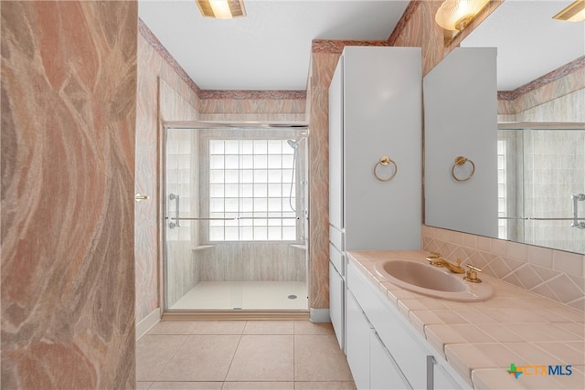 bathroom with vanity, a shower with shower door, and tile patterned flooring