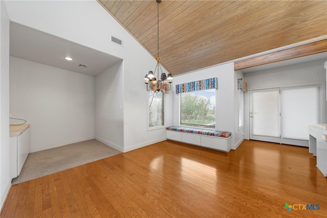 unfurnished dining area with carpet flooring, high vaulted ceiling, wood ceiling, and an inviting chandelier