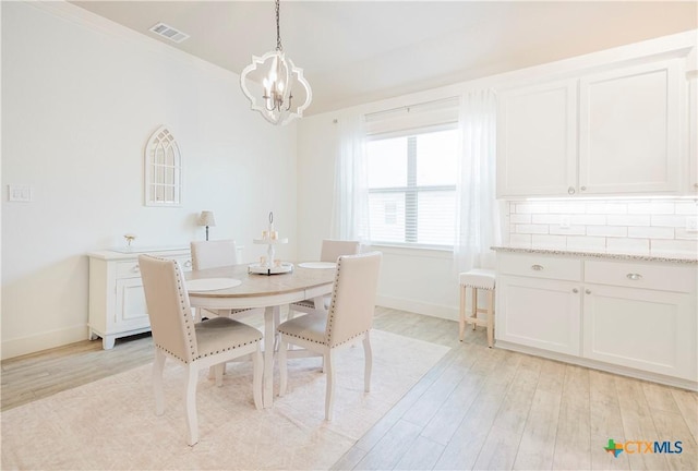2306 Wooster St, Nolanville, TX 76559 - dining area featuring an inviting chandelier, visible vents, baseboards, and light wood-style floors
