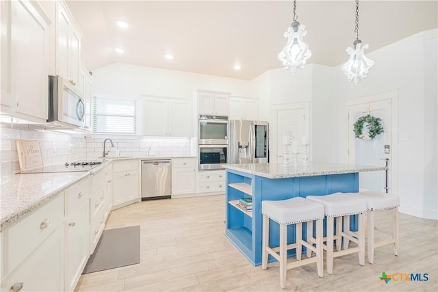 2306 Wooster St, Nolanville, TX 76559 - kitchen with decorative backsplash, a breakfast bar area, stainless steel appliances, open shelves, and white cabinetry