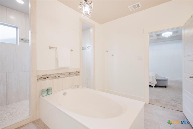 2306 Wooster St, Nolanville, TX 76559 - ensuite bathroom featuring tiled shower, a chandelier, ensuite bath, visible vents, and a garden tub