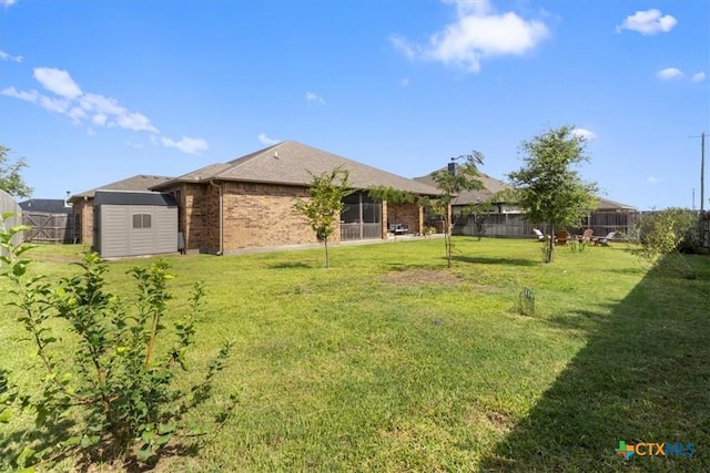2306 Wooster St, Nolanville, TX 76559 - rear view of property featuring a fenced backyard, brick siding, an outbuilding, a storage shed, and a lawn