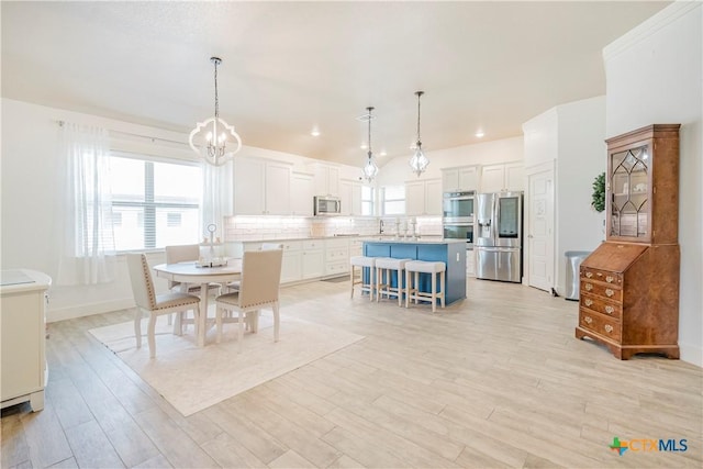 2306 Wooster St, Nolanville, TX 76559 - dining area with light wood finished floors, a notable chandelier, baseboards, and plenty of natural light