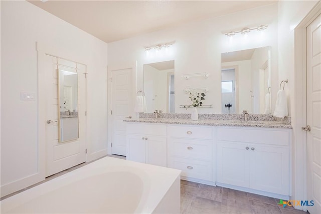 2306 Wooster St, Nolanville, TX 76559 - full bath featuring double vanity, a bath, and a sink