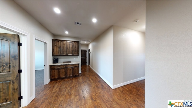 hallway with dark hardwood / wood-style flooring