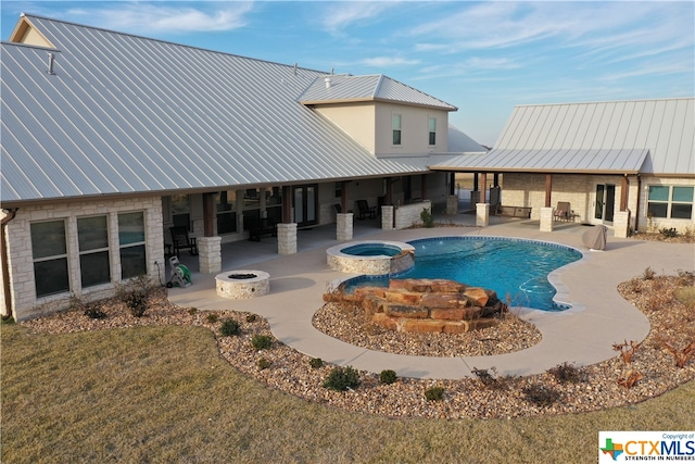 view of pool with a lawn, an in ground hot tub, and a patio area