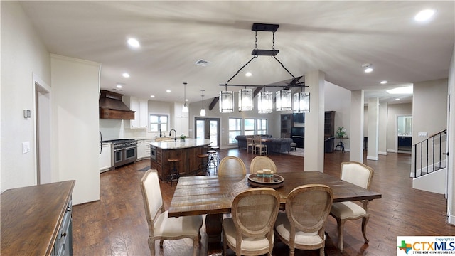 dining room featuring dark wood-type flooring and sink