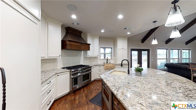 kitchen with white cabinetry, sink, double oven range, dark hardwood / wood-style floors, and custom exhaust hood