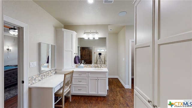 bathroom with vanity, hardwood / wood-style flooring, and a textured ceiling