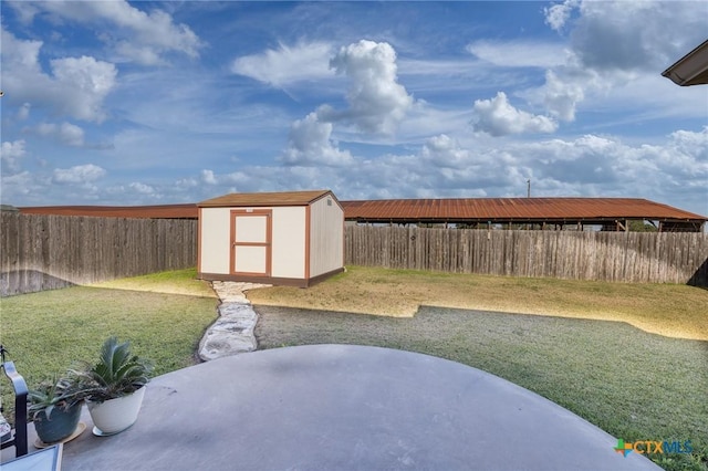 view of yard featuring a storage shed and a patio