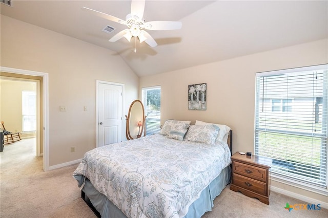 bedroom with ceiling fan, vaulted ceiling, and light carpet