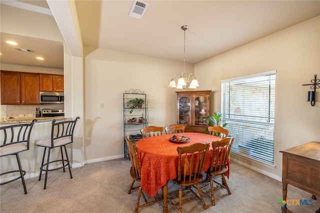 dining room featuring light carpet and an inviting chandelier