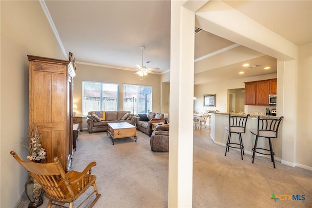 carpeted living room with ceiling fan and crown molding