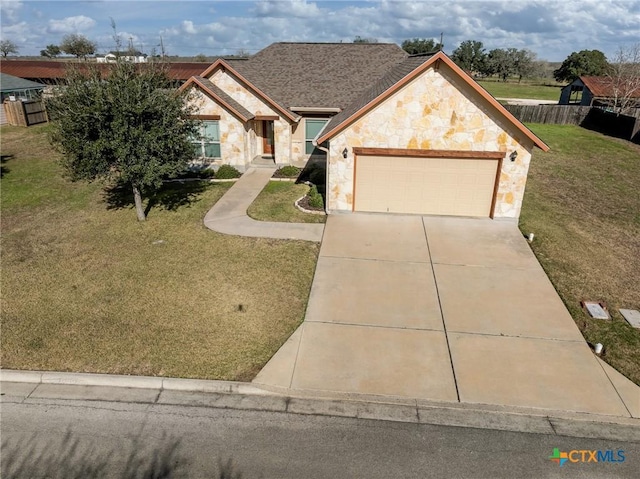 view of front of property with a front lawn and a garage