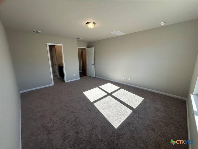 unfurnished bedroom with dark carpet