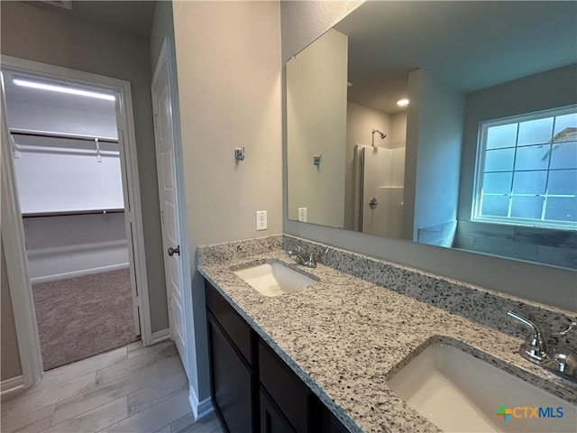 bathroom with a shower and vanity