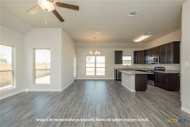 kitchen with decorative light fixtures, a wealth of natural light, wood-type flooring, and stainless steel appliances