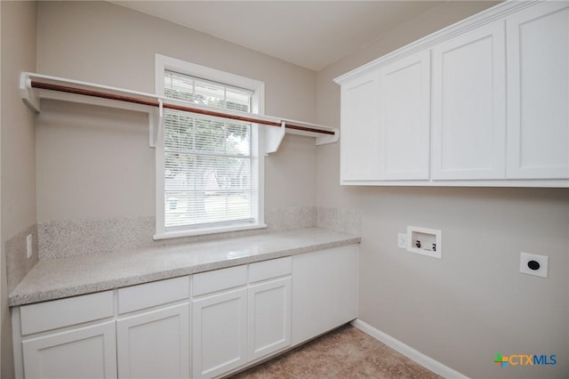 laundry area with cabinet space, hookup for a washing machine, baseboards, and electric dryer hookup