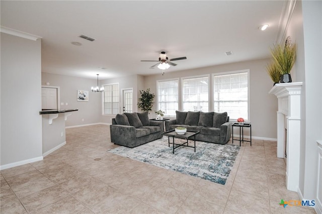 living area with light tile patterned floors, visible vents, baseboards, and ceiling fan with notable chandelier