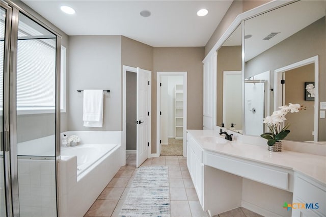 bathroom with visible vents, a shower stall, vanity, tile patterned flooring, and a bath