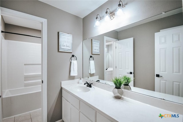 bathroom with shower / washtub combination, tile patterned flooring, and vanity