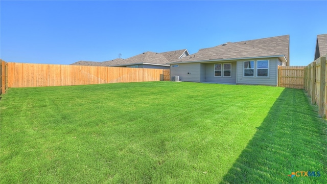 back of house with a lawn and cooling unit