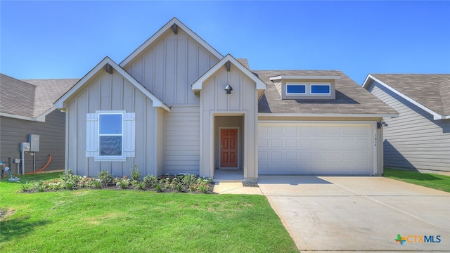 view of front of house featuring a garage and a front lawn