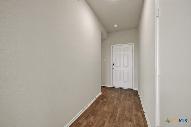 hallway with dark hardwood / wood-style flooring