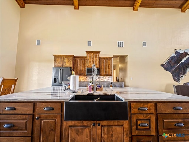 12093 Sulphur Springs Rd, Adkins, TX 78101 - kitchen with a sink, high end refrigerator, beam ceiling, light stone counters, and wooden ceiling