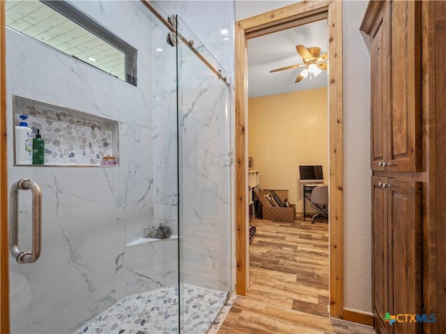 12093 Sulphur Springs Rd, Adkins, TX 78101 - full bathroom with wood finished floors, a marble finish shower, and ceiling fan