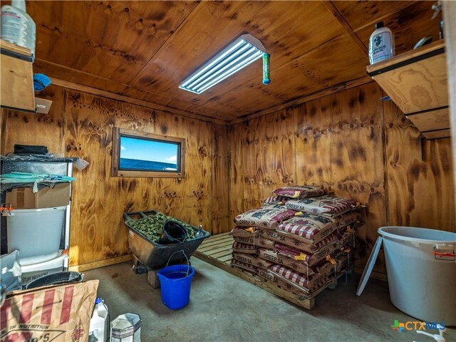 12093 Sulphur Springs Rd, Adkins, TX 78101 - bedroom with wooden ceiling, wooden walls, and unfinished concrete floors